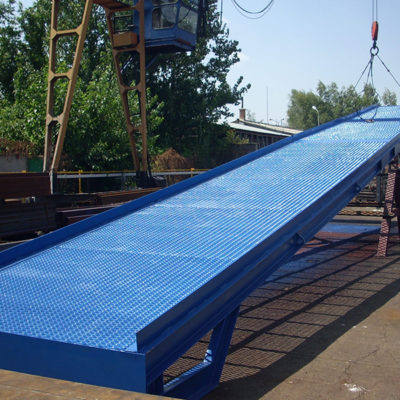 the crane is lifting up blue ramp for the cars, order bespoke mobile loading ramps