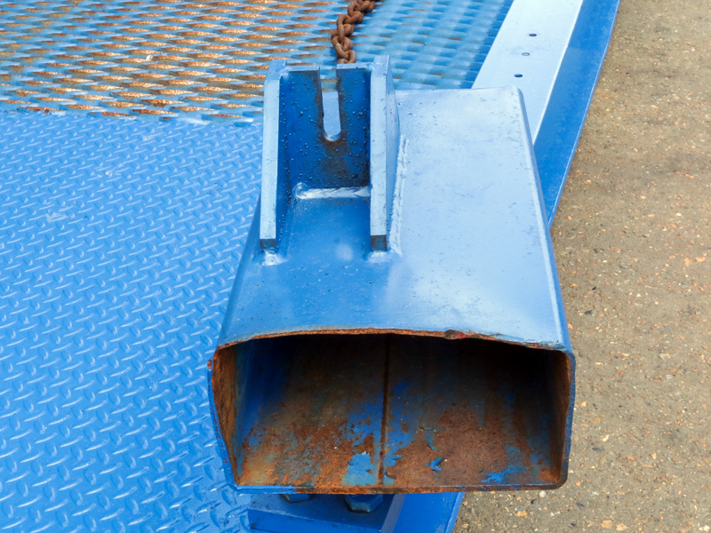 close-up on used blue loading ramps fork clamp